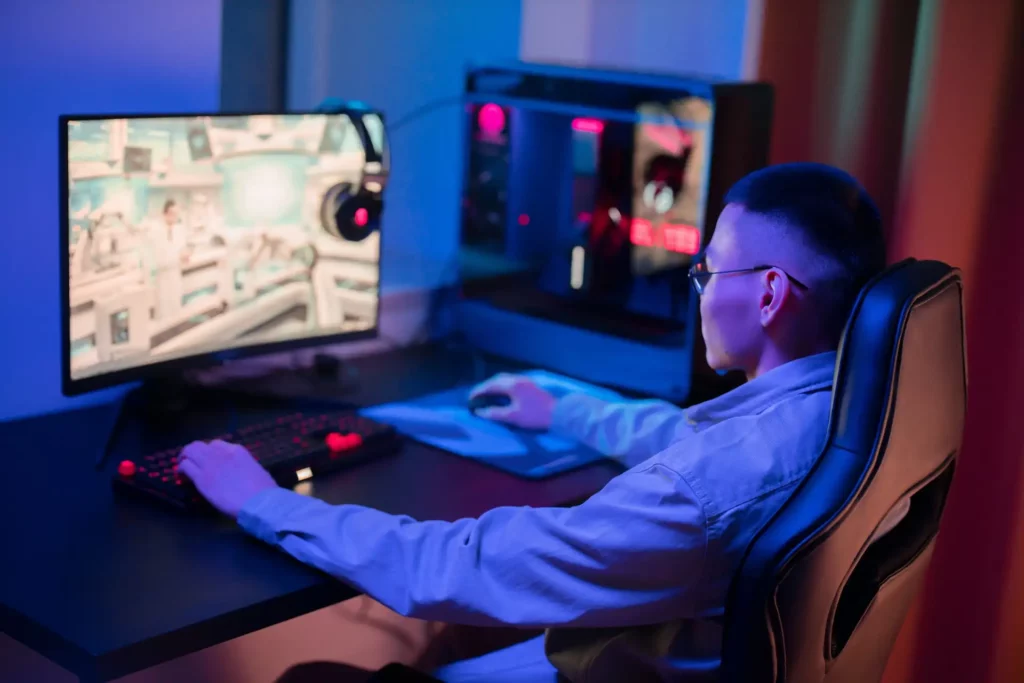 Guy playing on a gaming PC.